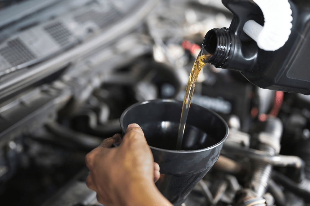 Close-up view of an oil change being performed on a honda vehicle engine