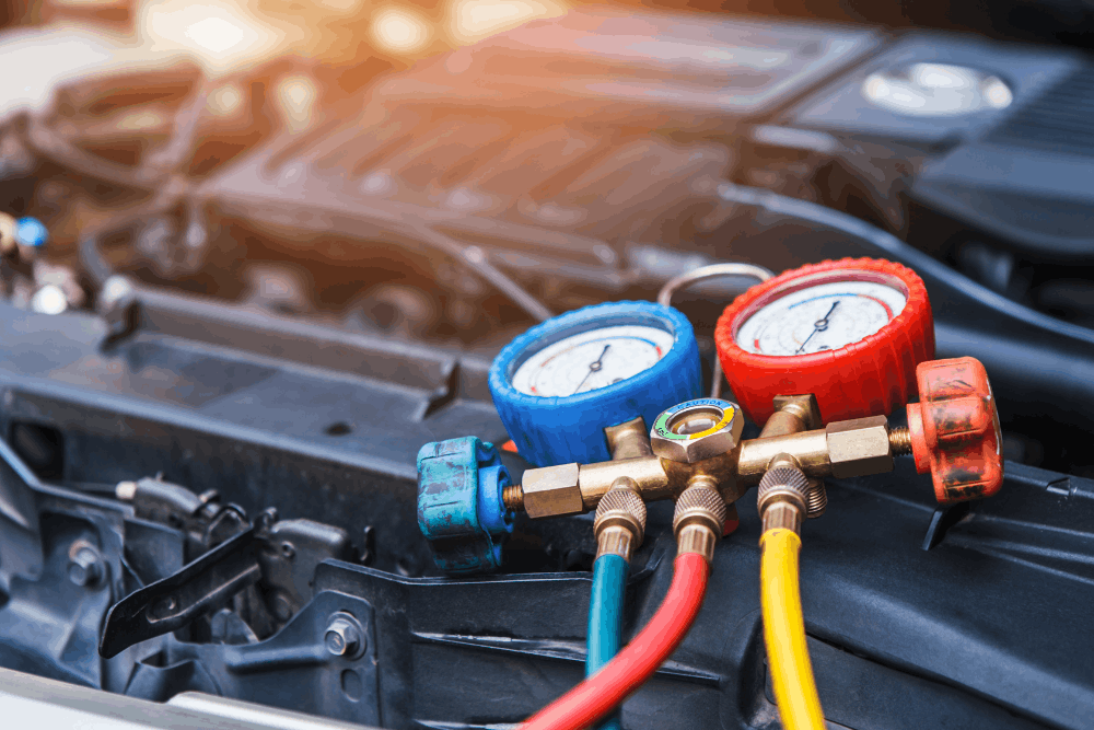 Car a/c repair, auto repair in West Point, VA, at Eltham Auto Clinic. Close-up image of professional A/C manifold gauges connected to a vehicle during automotive air conditioning diagnostics, refrigerant pressure testing, and A/C system repair.